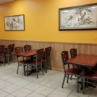 a dining area with tables and chairs