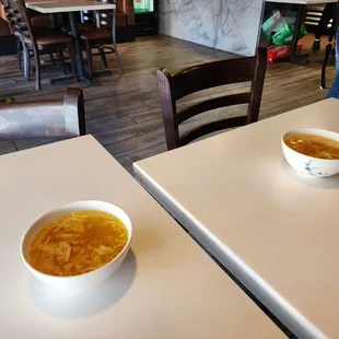 two bowls of soup on a table