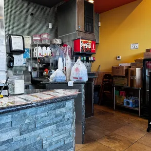 Drink machine and pick up to go order area.