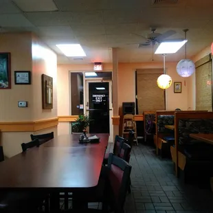 a dining area with tables and chairs