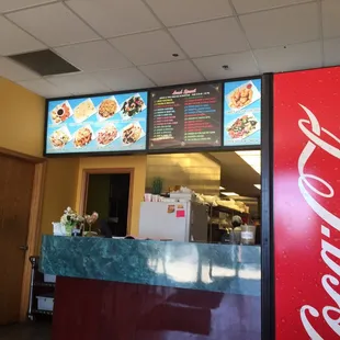 a coca cola machine and menus
