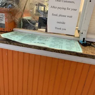 a sign on the counter of a restaurant