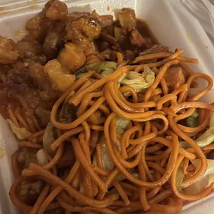 noodles and meat in a take out container