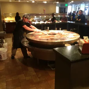 a woman preparing a pizza