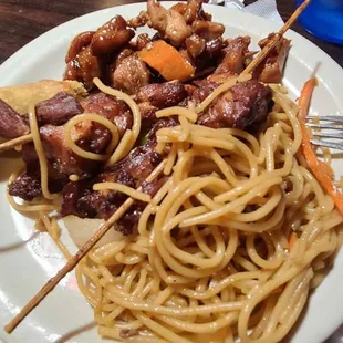 a plate of noodles and meat