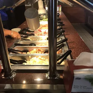 food being prepared in a buffet