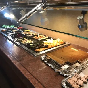 a variety of food on a buffet counter