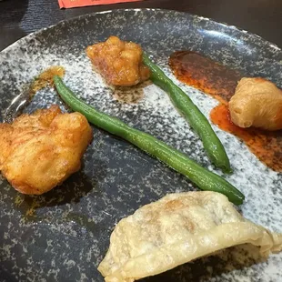 House chicken left, single piece of sweet and sour right and crispy pot sticker. All very good!