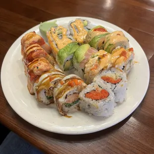 a plate of sushi and rolls