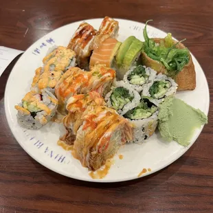 a plate of sushi and rolls