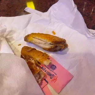 a half eaten sandwich on a napkin