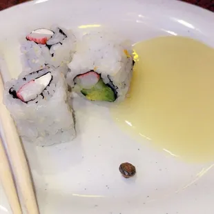 a plate of sushi and chopsticks