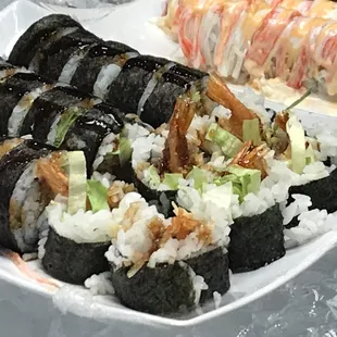 a plate of sushi and rolls