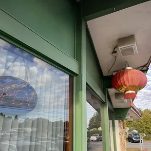 the reflection of a chinese lantern in the window