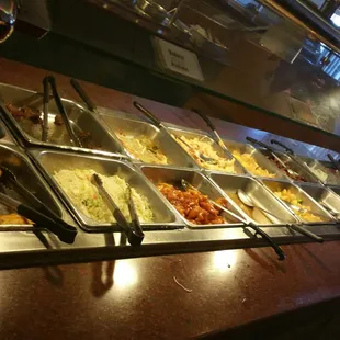 a variety of food in a buffet