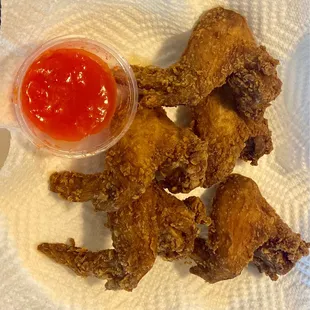 a plate of fried chicken with a side of ketchup