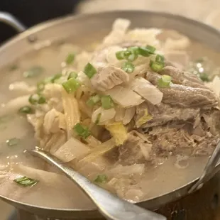 a bowl of soup with meat and vegetables