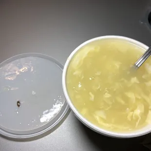 a bowl of soup and a container of soup
