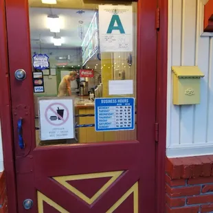 a red door with a sign on it