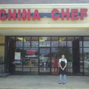 a woman standing in front of a restaurant