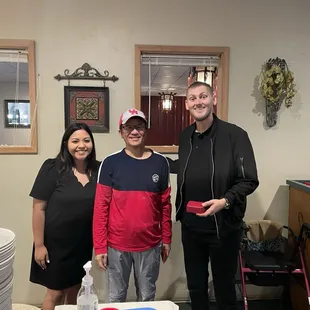 a man and a woman standing in front of a cake