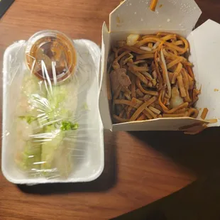 two take out boxes of food on a table