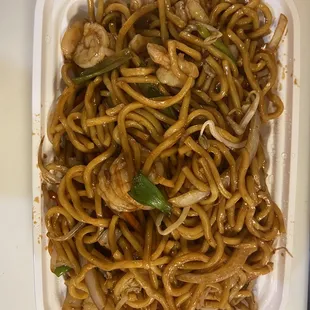 a plate of noodles and meat