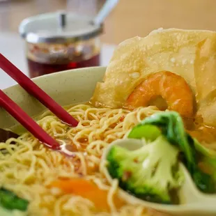 a bowl of noodles and chopsticks