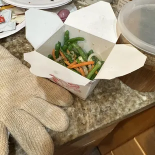 a box of vegetables on a kitchen counter