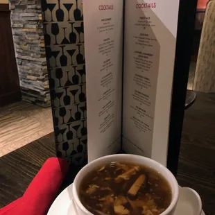 a bowl of soup and a menu