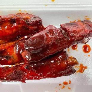 a close up of some meat in a styrofoam container