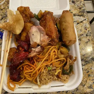 a plate of chinese food with chopsticks