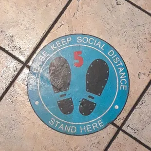 a blue sign with a pair of shoes on it