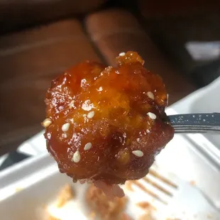 a fork holding a piece of food