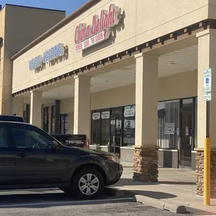 a car parked in front of a chinese restaurant