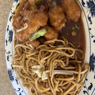 a plate of noodles and meat