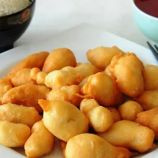 a plate of fried food with chopsticks