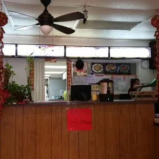 a chinese restaurant with a ceiling fan