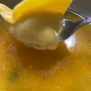 a spoon with a spoonful of soup
