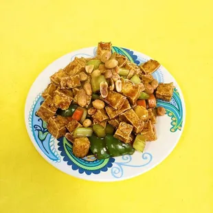 a plate of food on a yellow background