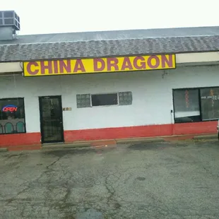 a white van parked in front of a chinese restaurant