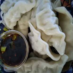 a plate of dumplings and sauce