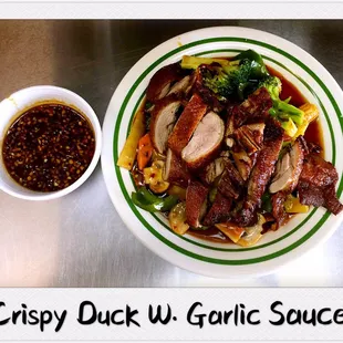 a bowl of chinese food and a bowl of sauce