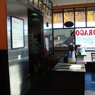 Order at the front, menu sitting on the front counter by the register.