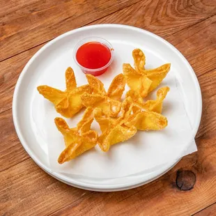 a plate of fried food on a wooden table