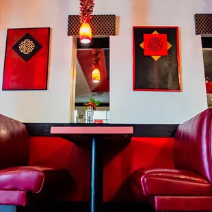 a restaurant with red booths and red chairs