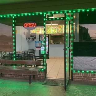 the front of a restaurant with green lights