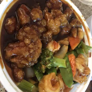 a bowl of chinese food on a table