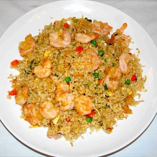 a plate of fried rice with shrimp and peas