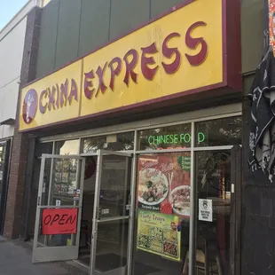 a woman standing in front of a chinese restaurant
